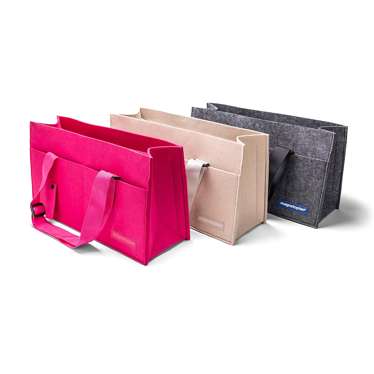 Trois sacs en feutre rectangulaires en rose, beige et gris posés côte à côte sur un fond blanc.